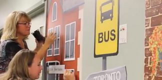 Art School of Peterborough exeutive director Jenni Johnston and volunteer Lori work on a mural in the C3 inpatient unit of Peterborough Regional Health Centre (PRHC). Last fall, a team of 16 volunteers with the art school painted for three days per week over two months to create the murals. (Screenshot from PRHC video)