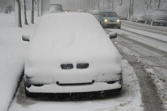 Winter snow on parked car