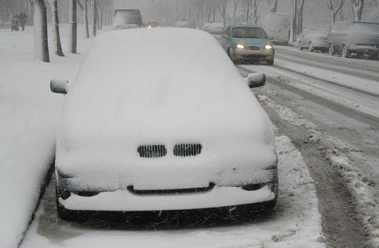 Winter snow on parked car
