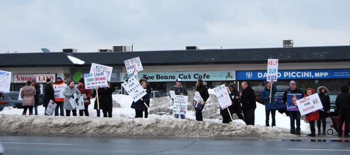 Some of the family members and autism advocates outside of Northumberland—Peterborough South MPP David Piccini's constituency office in Port Hope on February 15, 2019 to protest the Ontario government's changes to the Ontario Autism Program. (Photo: April Potter / kawarthaNOW.com)