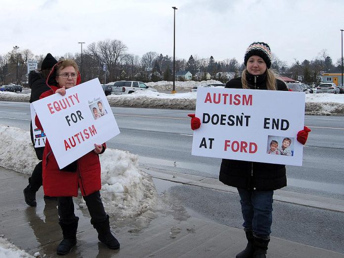 Lisa Devine (right), a mother of autistic twins, is supported by a family member at the  February 15, 2019 protest in Port Hope. (Photo: April Potter / kawarthaNOW.com)