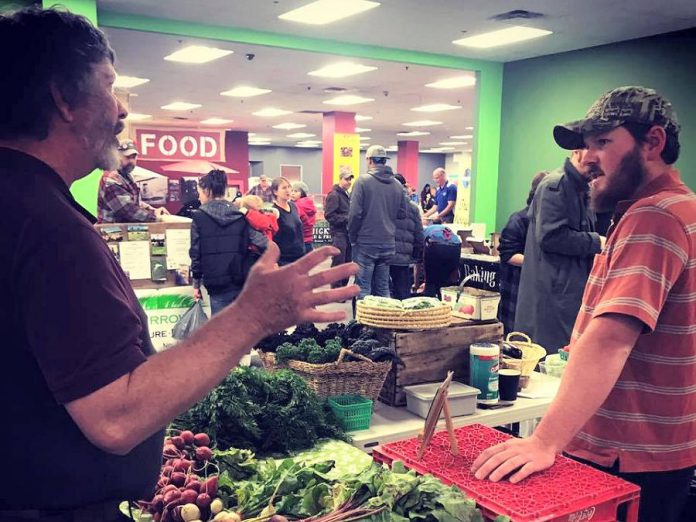 Sam McLean of McLean Berry Farm in Buckhorn and Trevor Riel of Riel Acres Farm north of Lakefield chat during market day at the Peterborough Regional Farmers' Market in Peterborough Square. The market runs at its winter location from 8 a.m. to 1 p.m. every Saturday until April. (Supplied photo)