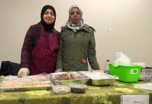 Two members of the Newcomer Kitchen in Peterborough on the first day at the winter location of the Peterborough Regional Farmers' Market in Peterborough Square. The market is donating vendor space for the group of Syrian refugees, who formed the Newcomer Kitchen to sell food including spinach pies, smoky baba ghanoush, and their very popular zaatar bread. (Photo courtesy of New Canadians Centre)