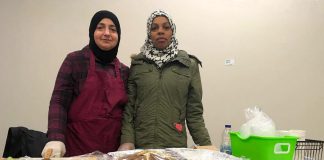 Two members of the Newcomer Kitchen in Peterborough on the first day at the winter location of the Peterborough Regional Farmers' Market in Peterborough Square. The market is donating vendor space for the group of Syrian refugees, who formed the Newcomer Kitchen to sell food including spinach pies, smoky baba ghanoush, and their very popular zaatar bread. (Photo courtesy of New Canadians Centre)