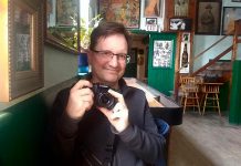 A rare photo of Peterborough photographer Andy Carroll, taken at The Only in downtown Peterborough. Preferring to stay behind his lens, Andy has quietly created an ongoing visual documentation of Peterborough's landscapes and culture, with a focus on theatre and music. (Photo: Sam Tweedle / kawarthaNOW.com)