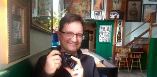 A rare photo of Peterborough photographer Andy Carroll, taken at The Only in downtown Peterborough. Preferring to stay behind his lens, Andy has quietly created an ongoing visual documentation of Peterborough's landscapes and culture, with a focus on theatre and music. (Photo: Sam Tweedle / kawarthaNOW.com)