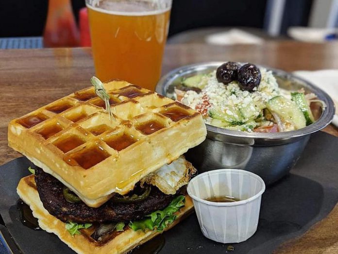 Port Hope's Olympus Burger is renowned for its creative burgers, like the Dionysus with a black bean patty, jalapeños, fried egg, lettuce, local maple syrup, and waffles instead of a regular bun. (Photo: Olympus Burger)