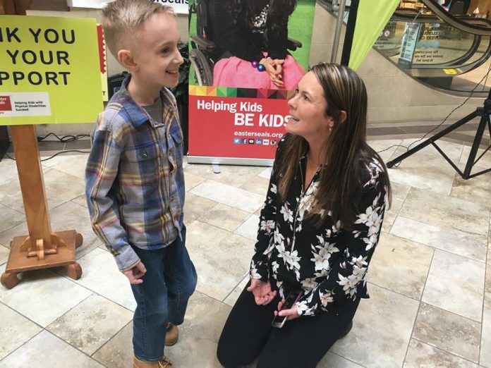 2019 Easter Seals Ambassador Ryerson Beardmore, 8, spends a few minutes catching up with Easter Seals senior development officer Coralie Jacobs at Lansdowne Place where details of the 47th annual Easter Seals telethon were announced on Wednesday (March 7th).  (Photo: Paul Rellinger / kawarthaNOW.com)