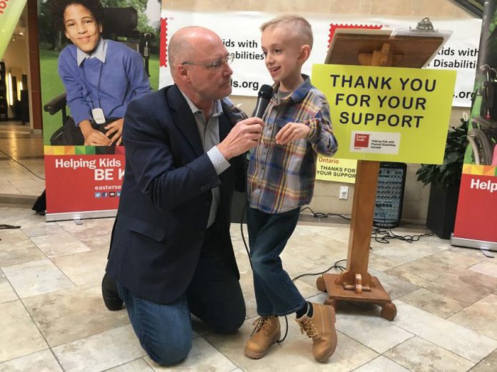 Peterborough Chamber of Commerce President and CEO Stu Harrison, who has been involved with the Easter Seals Telethon for 36 years, interviews the 2019 Ambassador Ryerson Beardmore on Wednesday (March 7th) at the Lansdowne Place kickoff announcement for the annual fundraiser, which takes place on Sunday, April 7th. Born with cerebral palsy, the 8-year0 old James Strath Public School student is now walking without the aid of assistive devices. (Photo: Paul Rellinger / kawarthaNOW.com)