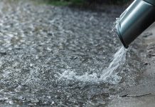 Heavy rain coming out of a downspout. (Stock photo0