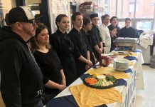 Juke Box Mania co-chairs Brad and Katie Watt (left), owners of Rare Grill, were joined by Kenner Collegiate culinary arts students and culinary arts teacher and Black Honey owner Lisa Dixon on Tuesday (March 5) for the official opening of registration for the April 26 music trivia-based fundraiser for Community Counselling and Resource Centre. (Photo: Paul Rellinger / kawarthaNOW.com)