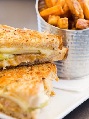 Sandwiches include a gourmet grilled cheese featuring locally made multigrain bread, brie, applewood smoked cheddar, fresh apple slices, and caramelized onions.  (Photo: Miranda Studios)