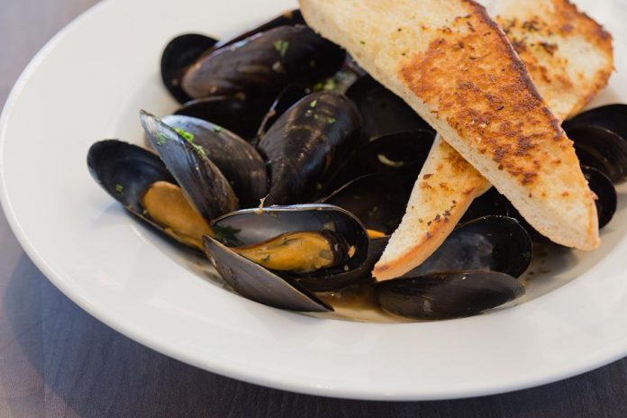 The recently renovated Riverside Grill Restaurant at Holiday Inn Peterborough-Waterfront in downtown Peterborough features a fresh new locally inspired menu that includes starters such as mussels steamed in Publican House beer. To celebrate the new menu, kawarthaNOW readers are eligible for a special deal for half-prized appetizers. (Photo: Miranda Studios)