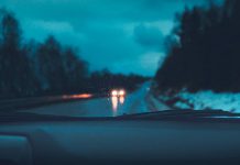 Rain and snow through a car's windshield at night