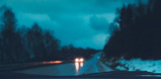 Rain and snow through a car's windshield at night