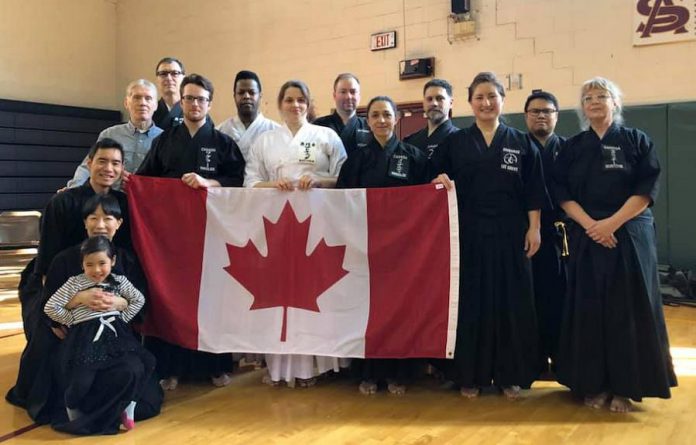 Warren Wagler (holding the Canadian flag at left) is the youngest member of Team Canada Iaido, which competed at the 2019 East Coast Iaido Taikai (competition) held in Jersey City, New Jersey on February 17, 2019. (Photo courtesy of  Team Canada Iaido)