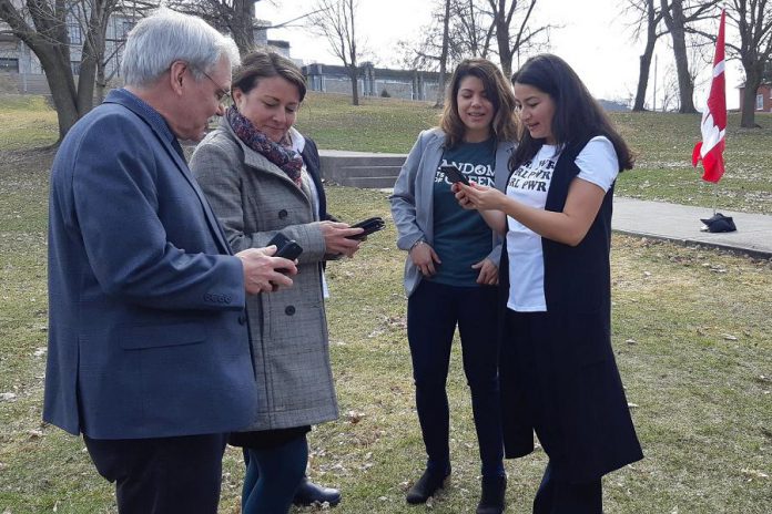 Selwyn Township mayor Andy Mitchell, Peterborough mayor Diane Therrien, and Peterborough-Kawartha MP Maryam Monsef (right) explore the Random Acts of Green mobile app as the social enterprise's founder and CEO Jessica Correa looks on, at the April 18, 2019 announcement of $200,000 in federal funding from the Climate Action Fund. The funding will help Random Acts of Green to develop and promote the mobile app, which measures and rewards Canadians for their 'green acts' to reduce greenhouse gas emissions. (Photo: Office of Andy Mitchell)