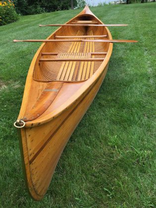 The 16-foot cedar-strip canoe constructed by renowned Lakefield boat-builder Walter Walker, along with a pair of hand-carved cherry paddles, will be auctioned off to the highest bidder at the Campfires & Cocktails fundraiser at  The Canadian Canoe Museum on May 4, 2019. Bids by proxy will also be accepted until May 3rd. (Photo courtesy of The Canadian Canoe Museum)