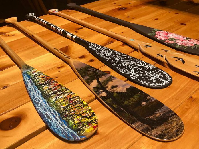 Dr. Roberta Bondar, Canada's first female astronaut, has created and donated a paddle (second from left) for the Campfires & Cocktails fundraiser, which takes place at The Canadian Canoe Museum on May 4, 2019. Also pictured are paddles created (from left to right) by Robert Atyeo, Tia Cavanagh, Randall Knott, and Robyn Jenkins. A total of 14 paddles, as well as cedar-strip canoe constructed by the late Lakefield boat builder Walter Walker, will be auctioned off during the event, with proceeds supporting the museum's educational and public programs. (Photo courtesy of The Canadian Canoe Museum)