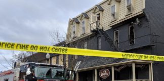 A member of Peterborough Fire Services takes photos following a fire that occurred around 4:52 a.m. on April 30, 2019 at 72 Hunter Street East in Peterborough's East City. One person is in a Toronto hospital with serious injuries following the fire, which the Ontario Fire Marshal and Peterborough Police Services are investigating. (Photo: Bruce Head / kawarthaNOW.com)