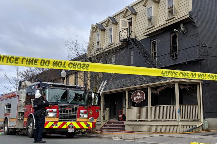 A member of Peterborough Fire Services takes photos following a fire that occurred around 4:52 a.m. on April 30, 2019 at 72 Hunter Street East in Peterborough's East City. One person is in a Toronto hospital with serious injuries following the fire, which the Ontario Fire Marshal and Peterborough Police Services are investigating. (Photo: Bruce Head / kawarthaNOW.com)