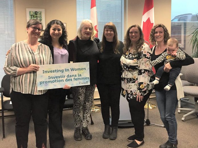 Staff and board members of the Elizabeth Fry Society of Peterborough pose with Maryam Monsef, Minister of International Development and Minister for Women and Gender Equality and Minister of International Development and Minister for Women and Gender Equality and Peterborough—Kawartha MP, on April 26, 2019 following an announcement of federal funding.. The organization is one of six women's oroganizations in Ontario that are receiving funding under the Government of Canada's Capacity-building Fund. From left to right: board chair Frances Wilbur, Minister Maryam Monsef, board member Marlis Lindsay, board treasurer Mary Goddard, executive director Debbie Carriere, and board member Emily Rashotte with Clive. (Photo: Elizabeth Fry Society of Peterborough / Facebook)