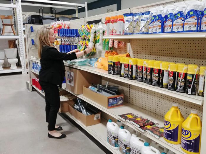 Christina Skuce, director of philanthropy and communications with Habitat for Humanity Peterborough and Kawartha Region, organizes new items that were donated by Habitat's generous corporate partners. Items like kitchen cleaning products and paint supplies are often discontinued or overstocked and can be bought at a discounted price at the ReStore. (Photo courtesy of Habitat for Humanity Peterborough and Kawartha Region)