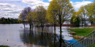 In 2017, Little Lake rose above the retaining walls and flooded the parking lot at Ashburnham Lock 20 at Beavermead Park in Peterborough. While water levels are not yet this high, the City of Peterborough remains under a flood warning as water levels will continue to rise along the Kawartha Lakes and Otonabee River and 25 to 45 millimetres of rain is forecast for Friday. (Photo: Bruce Head / kawarthaNOW)