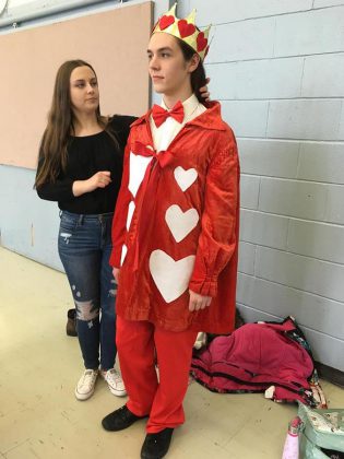 Miranda Steiginga helping Ben Stevenson with his costume as The King of Hearts during a rehearsal of  "Alice @ Wonderland: The Musical". (Photo:  Jim Mills)