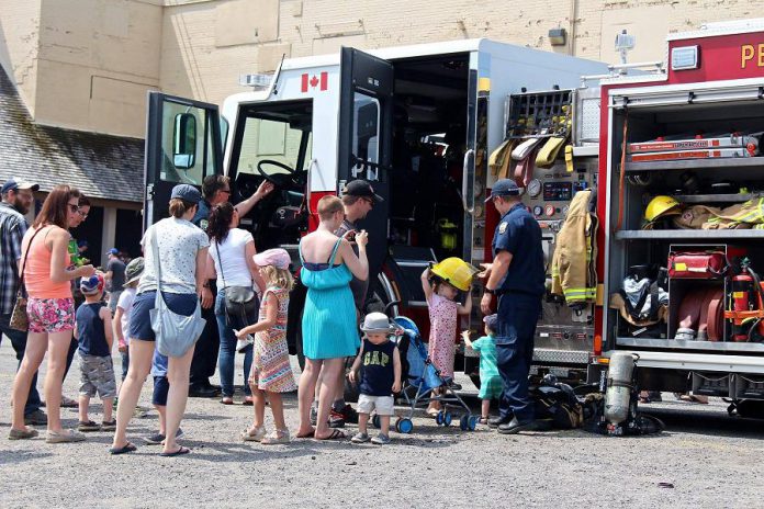 Families explore a fire truck from Peterborough Fire Services during the 2018 Touch-A-Truck event at The Canadian Canoe Museum. (Photo courtesy of The Canadian Canoe Museum)