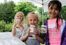 Students attending the 2018 Peterborough Children's Water Festival hold up their favourite invertebrates. The Otonabee Conservation activity centre allowed children to get up close with many aquatic bugs and insects to understand how their unique features allow them to live in water. Last year's festival had registration numbers, prompting the festival's steering committee to add a third day in 2019. (Photo: Karen Halley / GreenUP)