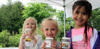 Students attending the 2018 Peterborough Children's Water Festival hold up their favourite invertebrates. The Otonabee Conservation activity centre allowed children to get up close with many aquatic bugs and insects to understand how their unique features allow them to live in water. Last year's festival had registration numbers, prompting the festival's steering committee to add a third day in 2019. (Photo: Karen Halley / GreenUP)
