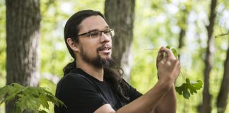 Joe Pitawanakwat, founder and director of indigenous outdoor-education based business Creators Garden, holds a leaf from a bloodroot plant during a guided indigenous medicine walk at Ballyduff Trails, located on the McKim-Garsonnin property protected by Kawartha Land Trust. He explained the use of the highly toxic plant in traditional medicine to help treat fibroids and as an aid for pregnancy. (Photo: Anica James)