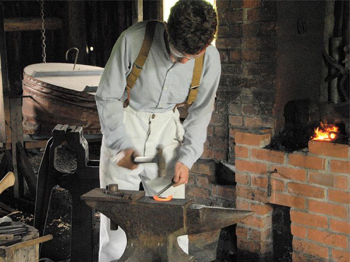 A blacksmith at work at Lang Pioneer Village Museum in Keene.  (Photo courtesy of Lang Pioneer Village Museum)