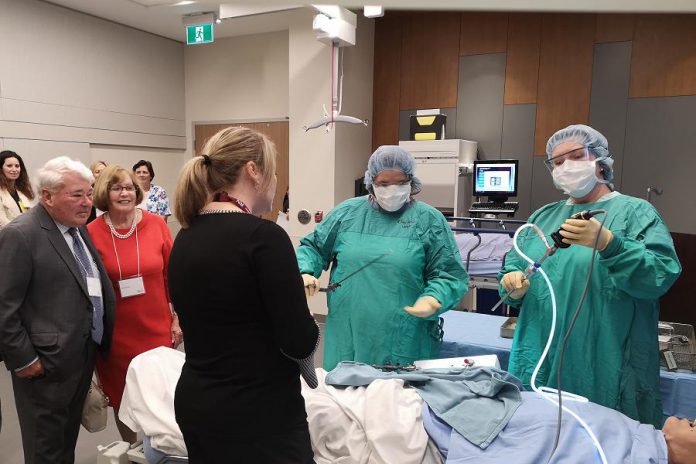 Donors Martin and Denise Pick (left) watch a demonstration in the clinical training room at the new Martin and Denise Pick Learning Centre at Peterborough Regional Health Centre on May 14, 2019 with nurse educator Christine Emrich (back to the camera), with  other community donors and PRHC staff.  (Photo: Natasha Roulston / Peterborough Regional Health Centre)