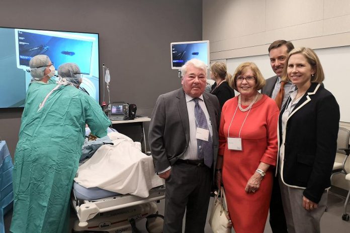 Martin, Denise, and Charles Pick with Dr. Rardi van Heest at the official dedication of the new Martin and Denise Pick Learning Centre at Peterborough Regional Health Centre on May 14, 2019. They toured the clinical training room, where a simulation of minimally invasive surgical training was demonstrated. (Photo: Natasha Roulston / Peterborough Regional Health Centre)