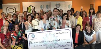 Some of the members of 100 Women Peterborough with representatives from Five Counties Children's Centre, including 15-year-old client Rebecca Jordan and board chair Adam White (both holding the cheque). The non-profit organization that provides therapy services for children will receive more than $10,000 from the group. (Photo courtesy of 100 Women Peterborough)