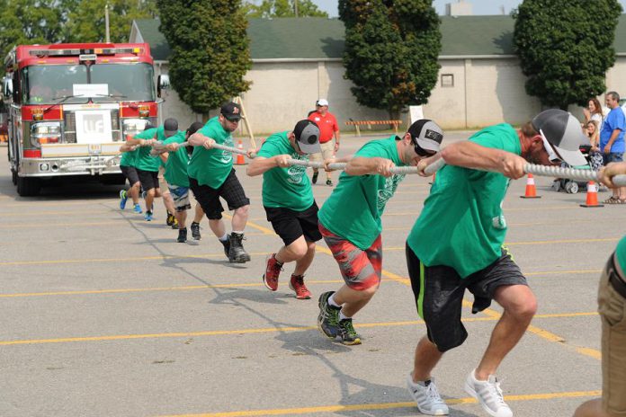 A team uses a front-pull strategy during a previous Pulling for Dementia Fire Truck Pull. Before pulling, teams are taught the proper technique during a practice round to get the best result and avoid any injury. (Photo: Bianca Nucaro / 705 Creative)