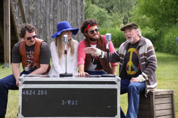 Owen Stahn, Kate Suhr, and Griffin Clark act out a scene from "Bloom: A Rock 'n' Roll Fable" with Geoff Hewitson (who plays the role of a CHUM Radio DJ as well as portraying legendary Peterborough band leader and music promoter extraordinaire Del Crary) during a media day at 4th Line Theatre on June 19, 2019. (Photo: Jeannine Taylor / kawarthaNOW.com)