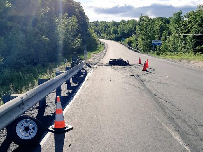 A motorcycle has been destroyed by fire and the driver is in hospital with life-threatening injuries following an accident on Highway 118 in Highlands East on June 16, 2019. A passenger also suffered injuries. (Photo: Bancroft OPP)