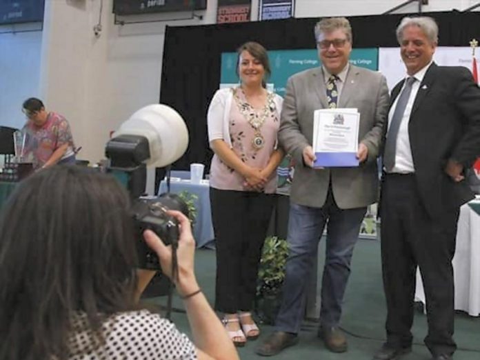 Peterborough Folk Festival Malcolm Byard accepts a Civic Award on behalf of Ryan Kemp and himself from City of Peterborough Mayor Diane Therrian and Councillor Dean Pappas. (Photo: Peterborough Folk Festival / Facebook)