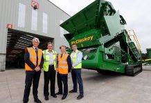 Peterborough-based McCloskey International, which employs around 900 people in Canada, the U.S.A., and Northern Ireland, has been acquired by Finnish industrial machinery company Metso. Pictured are McCloskey International founder, president, and CEO Paschal McCloskey (second from left) and Ian Lough of McCloskey International (far right), along with Mark Nodder and Jeremy Fitch of Invest Northern Ireland at Granville Industrial Estate in County Tyrone in Northern Ireland. (Photo: McCloskey International)