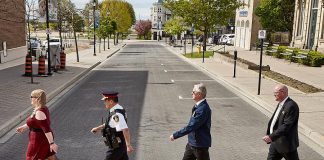 Representatives from community groups, the Cobourg Police Service, and the Town of Cobourg mimic the famous cover of The Beatles' Abbey Road album during the celebration of the new rainbow crosswalk at King Street West and Second Streets in downtown Cobourg. The crosswalk, which was unveiled during Pride Month in Cobourg, will remain in place for the rest of the summer. (Photo: Town of Cobourg / Facebook)