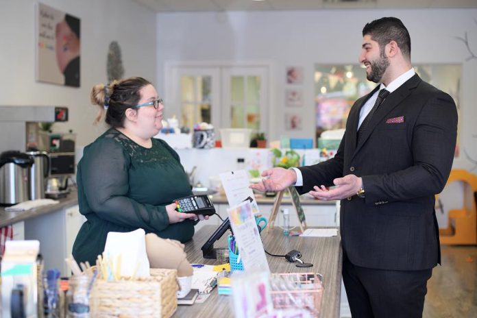 Sarah Susnar, owner and operator of family activity studio Play Cafe, meets with Waleed Dabbah of Dabbah Corp. Sussner says Dabbah is not only knowledgeable, responsive, and friendly, but he saved her business 40 per cent over the best rate the banks offered for a point of sale system. (Photo: 705 Creative / kawarthaNOW)