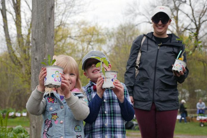 Two young children show off their new native plants they selected at the 2019 GreenUP Ecology Park plant sale in May. (Photo: GreenUP)