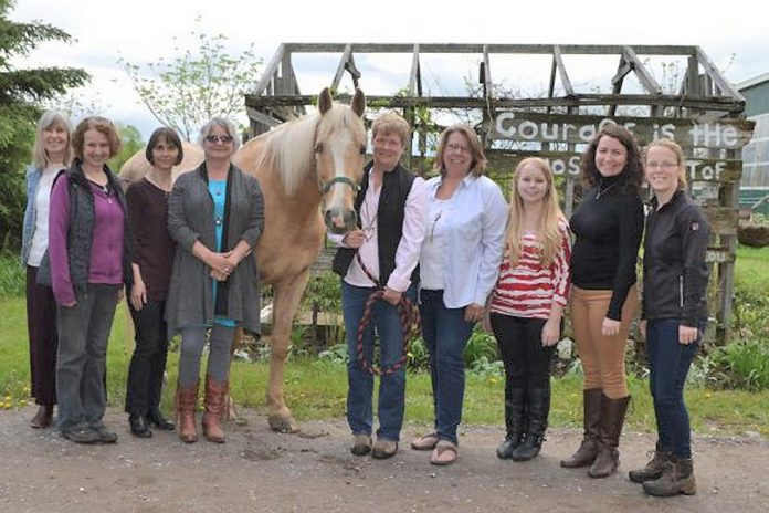 The team behind the Building Internal Resilience Through Horses program (left to right): Cheryl Wood, Beverley Clifton, Dr. Kateryna Keefer, Susan Hardy, Sunny the horse, Jennifer Garland, Sonya Vellenga, Nicole Oattes, Katie McKeiver, and Vivianne Burmester. (Supplied photo)