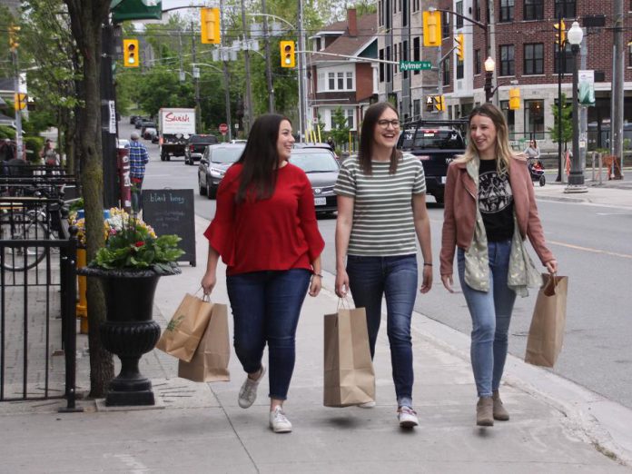 Aldana Casado, Kate Storen, and Chelsea Boyd of the Main Street Digital program (a DBIA initiative to help downtown businesses improve their online presence) at the launch of 'Open Late 'Til Eight', a new shopping initiative that will see 27 retail stores in downtown Peterborough stay open until 8 p.m. on Thursdays and Fridays this summer. (Photo: Jeannine Taylor / kawarthaNOW.com)