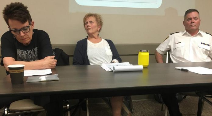 There were no happy faces among the three speakers at a public meeting on the opioid crisis on June 12, 2019 at the Lions' Community Centre in Peterborough. From left to right: Whitepath Consulting and Counselling Services owner Peggy Shaughnessy, PARN  executive director Kim Dolan, and Peterborough Deputy Police Chief Tim Farquharson.  Around 100 people showed up for the meeting. (Photo: Paul Rellinger / kawarthaNOW)