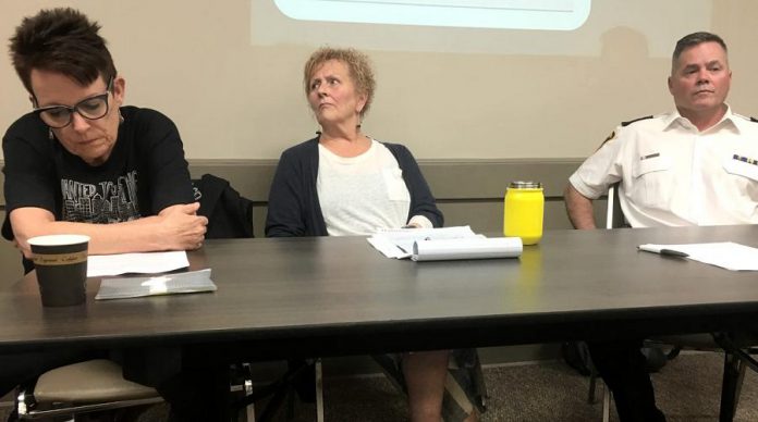 Whitepath Consulting and Counselling Services owner Peggy Shaughnessy (left) during a June 12th public meeting on Peterborough's opioid crisis at the Lions' Community Centre in Peterborough. As a frontline expert in drug overdose, treatment, and counselling, Shaughnessy was disappointed that she wasn't initally invited to participate on the panel for the July 11th 'Opioid Summit' being hosted by Peterborough Mayor Diane Therrien and Selwyn Deputy Mayor Sherry Senis. Following negative reaction from some members of the community, Mayor Therrien has now invited Shaughnessy to participate. Peterborough Deputy Police Chief Tim Farquharson (right) is already participating on the July 11th panel, which PARN executive director Kim Dolan (centre) will be moderating. (Photo: Paul Rellinger / kawarthaNOW)