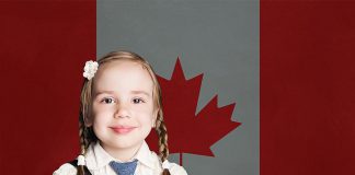 A young female student in front of the Canadian flag